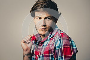 Caucasian man wearing checkered shirt and trendy hairstyle