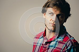 Caucasian man wearing checkered shirt and trendy hairstyle