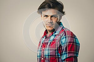 Caucasian man wearing checkered shirt and trendy hairstyle