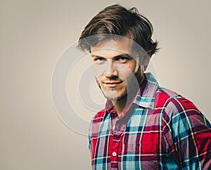 Caucasian man wearing checkered shirt and trendy hairstyle