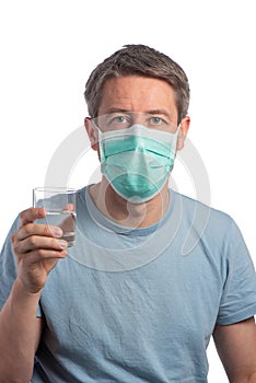 Caucasian man wearing a protection mask with a glass of water on a white background