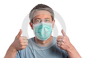 Caucasian man wearing a protection mask making victory sign on a white background