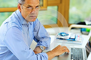 Caucasian man working on his laptop computer.