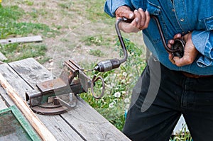 Caucasian man working with the old hand drill