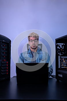 Caucasian man working with programming in dark background. Hacker, engineer, program developer concept