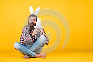 Caucasian mature hipster in buny ears with trendy hairstyle in checkered shirt celebrate easter, copy space, easter joy