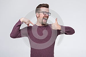 Caucasian mature man in glasses with beard being proud of himself