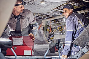 Caucasian men mechanics and technicians are repairing aircraft in the indoors