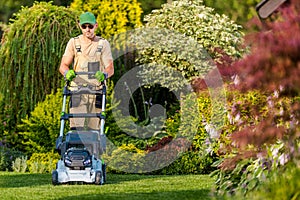 Caucasian Men Mowing Grass in His Garden