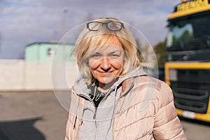 Caucasian mid age woman driving truck. trucker female worker, transport industry occupation