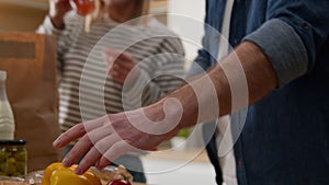 Caucasian middle-aged couple happy family senior adult wife and husband woman and man unpack delivered paper bag package