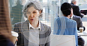 Caucasian middle-aged woman with gray hair talking