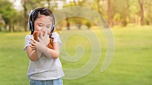 Caucasian mix girls hug teddy bear doll at outdoors park, Picnic time