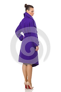 The caucasian model in purple coat isolated on white
