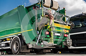 Caucasian Modern Garbage Truck Worker and the Vehicle