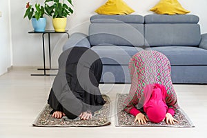 caucasian Muslim girls Praying Sujud at home.