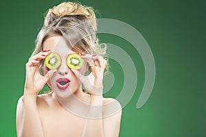 Caucasian Nude Model Making Faces while Posing With Two Kiwi Slices
