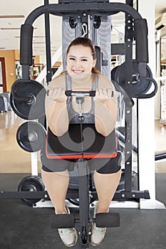 Caucasian obese woman exercising her biceps