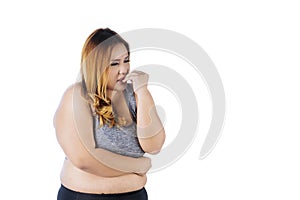 Caucasian obese woman looks anxious on studio