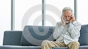 Caucasian old senior elderly unhealthy sick ill male husband grandpa sitting on sofa at home