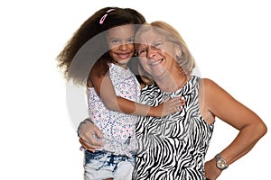 Caucasian older woman hugging her african american granddaughter