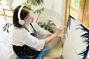 Caucasian painter creating an oil painting
