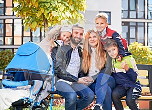 Caucasian parents with cute children having rest in city.