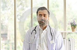 Caucasian physician portrait. Doctor with stethoscope portrait in uniform at hospital. Healthcare and medicine concept