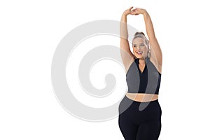 A Caucasian plus size model on white background stretches her arms up, copy space