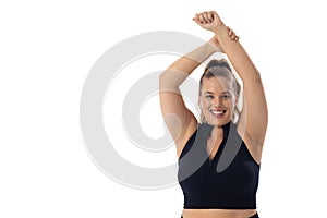 Caucasian plus-size young woman stretches arms up on white background, copy space