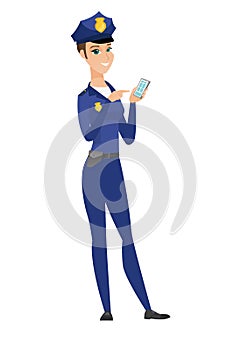 Caucasian policewoman holding a mobile phone.