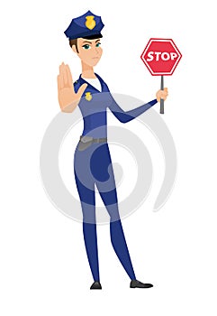 Caucasian policewoman holding stop road sign.