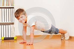 Caucasian preschooler boy making gymnastics