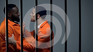 Caucasian prisoner fighting with black inmate, discrimination, jail overcrowding photo