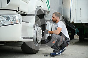 Caucasian Professional Truck Mechanic Rebuilding Heavy Duty Truck Diesel Engine. Automotive Industry Theme.