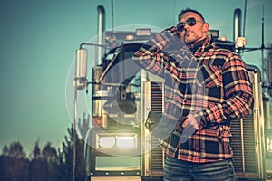 Caucasian Professional Trucker in Front of His Truck