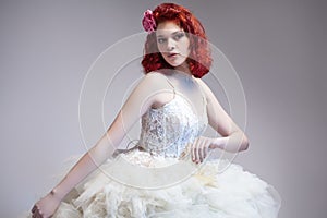 Caucasian Red-Haired Female in Tailored Wedding Dress.
