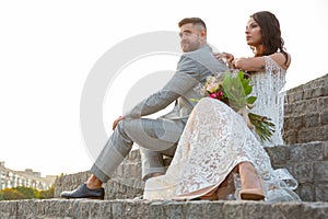 Caucasian romantic young couple celebrating their marriage in city