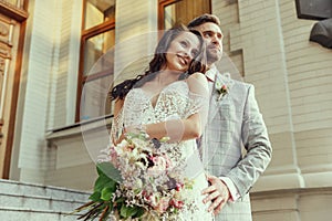 Caucasian romantic young couple celebrating their marriage in city