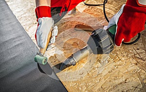 Caucasian Roofing Worker Installing EPDM Membrane Material