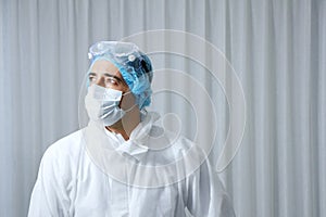 Caucasian Scientific experimenter man Wearing blue protective rubber gloves and standing in Laboratory. Science and covid19 visus