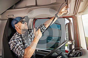 Caucasian Semi Truck Driver Talking by CB Radio