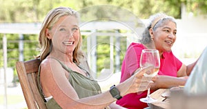 Caucasian and senior biracial women enjoy a sunny outdoor setting