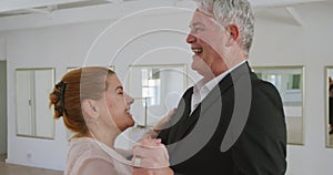 Caucasian senior couple spending time together dancing in a ballroom
