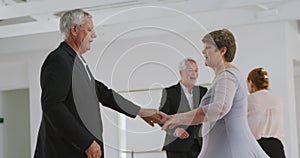 Caucasian senior couples spending time together dancing in a ballroom