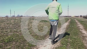 Caucasian senior man running lonely while training on a country road