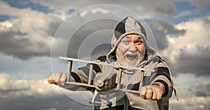 caucasian senior man on sky background. senior man at retirement. senior retired man with toy plane