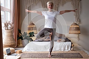 Caucasian senior woman in yoga pose vrikshasana, tree pose