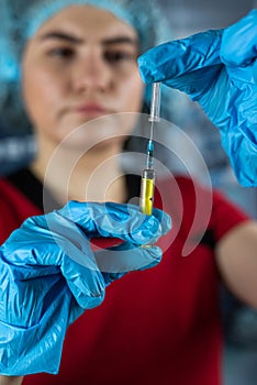 caucasian serious woman nurse or doctor hold syringe preparing patients vaccination antibiotic