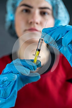 caucasian serious woman nurse or doctor hold syringe preparing patients vaccination antibiotic